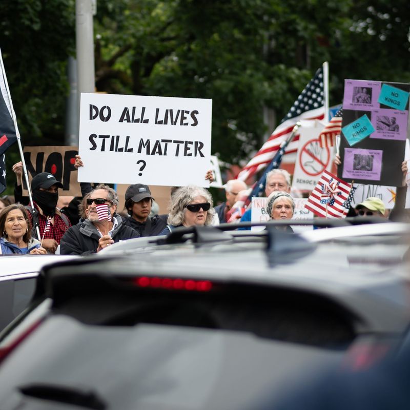 Protestors for "No Kings" stand along the Memorial Parkway in Utica, NY on Saturday, June 14, 2025, as part of a nationwide day of peaceful protest against the Trump administration.