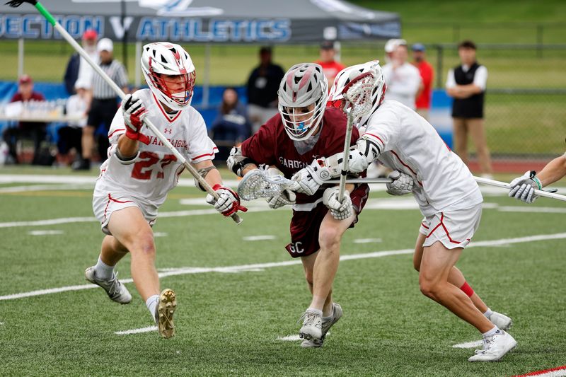 Canandaigua’s Will Rheude and Michael Belles double team Garden City’s Merit Ruckh.