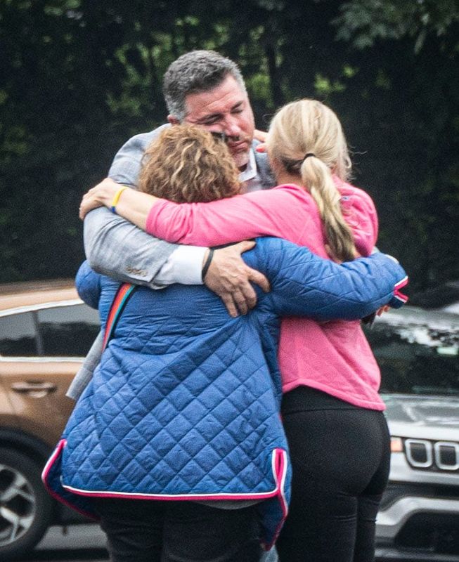 Carl Sturino, the nephew of Lesley Kawejsza, embraces Kawejsza's daughters Kristen Kawejsza and Katelyn Doerner June 18, 2025, the morning after Lesley Kawelsza died in an overnight house fire in her Eastchester home.