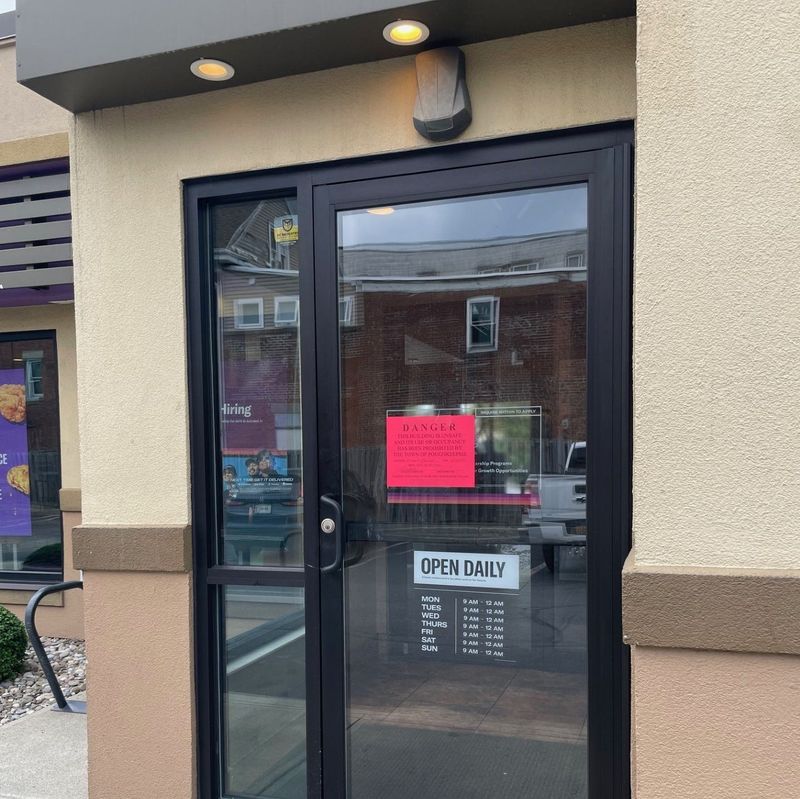 A sign on the Taco Bell on Main Street in Poughkeepsie indicates the building has been closed by the town.