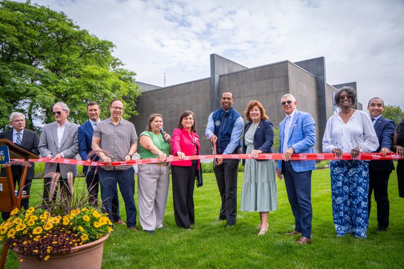 State officials, local elected officials and officials from Munson took part in a ceremonial ribbon cutting on June 18, 2025 at Munson n Utica to mark the completion of a Downtown Revitalization Initiative project to transform the landscaping between the museum and Genesee Street.