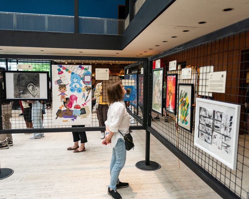 A woman checks out the community exhibition during Juneteenth @ Munson in Utica, NY on Thursday, June 19, 2025.