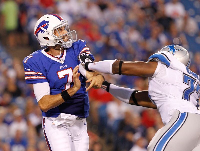 Aug 29, 2013; Orchard Park, NY, USA; Buffalo Bills quarterback Matt Leinart (7) gets hit by Detroit Lions defensive end Israel Idonije (77) after a pass during the first half at Ralph Wilson Stadium.