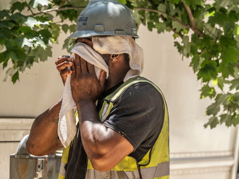 Calvin Ellison wiped sweat from his face as he attempted to stay cool while working in the severe heat June 24, 2025. McCormick was part of a crew installing underground natural gas lines at a construction site in Pelham, New York. Temperatures reached near triple digits in parts of the Lower Hudson Valley as the heat wave that has blanketed much of the East Coast continued into the work week.