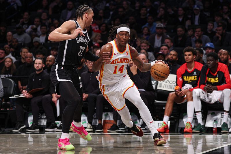 Mar 16, 2025; Brooklyn, New York, USA; Atlanta Hawks guard Terance Mann (14) goes to the basket as Brooklyn Nets forward Jalen Wilson (22) during the first half at Barclays Center. Mandatory Credit: Vincent Carchietta-Imagn Images