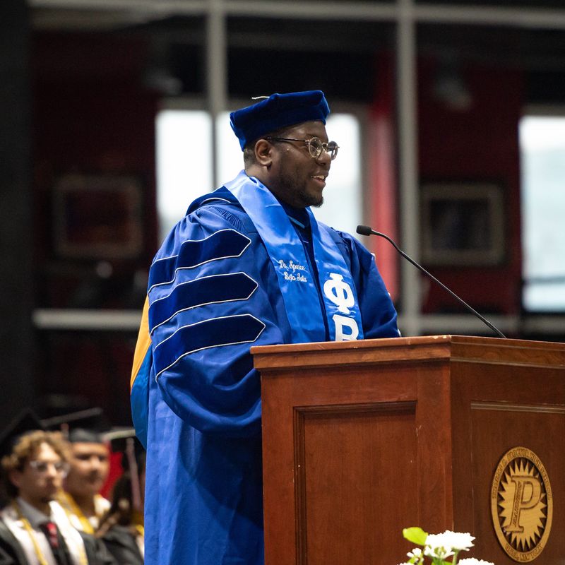 Utica schools Superintendent Christopher Spence speaks at last year's graduation ceremony in this file photo from June 27, 2025. Spence's three-year contract expires at the end of the 2026-2027 school year and some residents are already speaking out, urging the board to extend it.