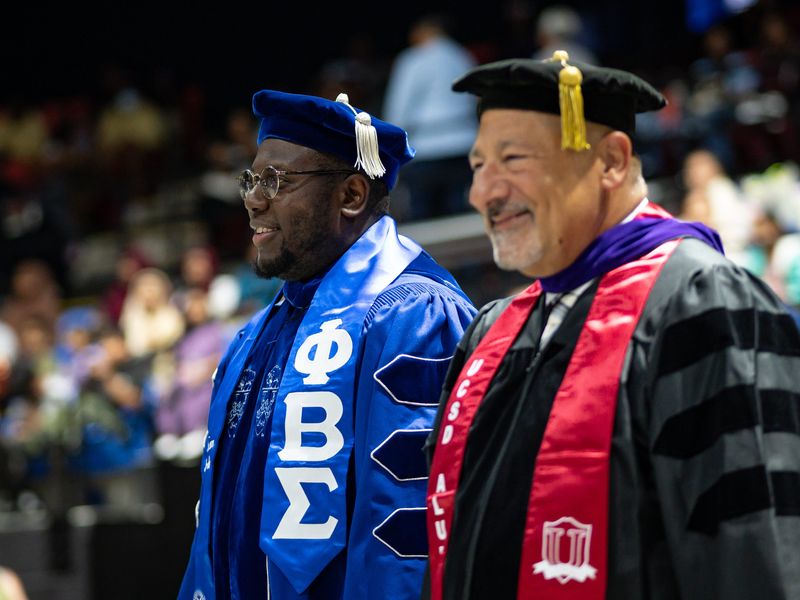 Superintendent Christopher M. Spence, Ph.D and President of the Board of Education Joseph Hobika Jr. walk in and take their seats during Thomas R. Proctor High School's 2025 Commencement Ceremony at the Adirondack Bank Center in Utica, NY on Friday, June 27, 2025.