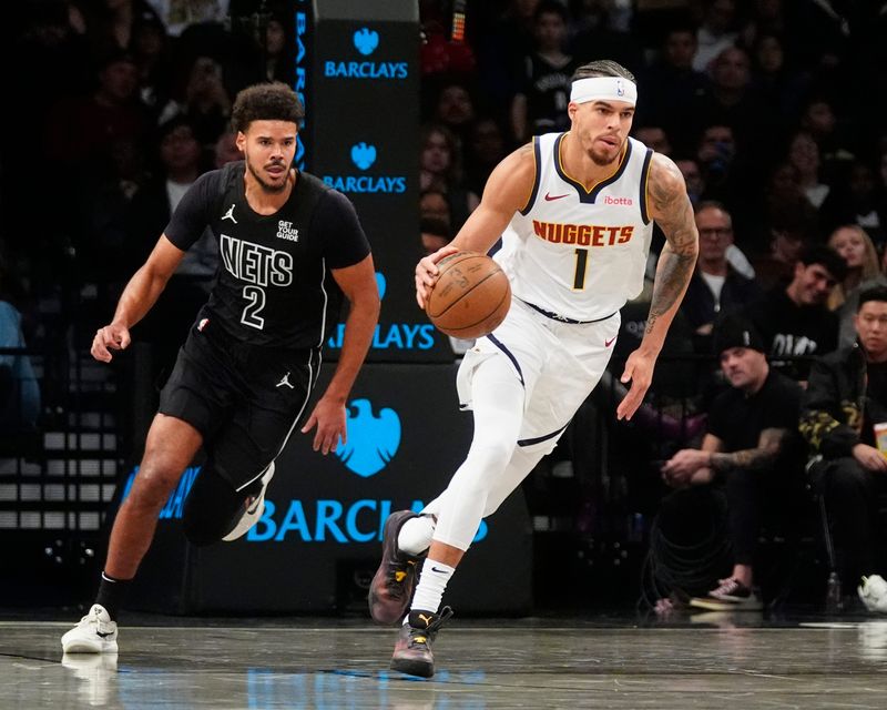 Oct 29, 2024; Brooklyn, New York, USA; Denver Nuggets small forward Michael Porter Jr. (1) dribbles the ball up the court past Brooklyn Nets small forward Cameron Johnson (2) during the first half at Barclays Center. Mandatory Credit: Gregory Fisher-Imagn Images