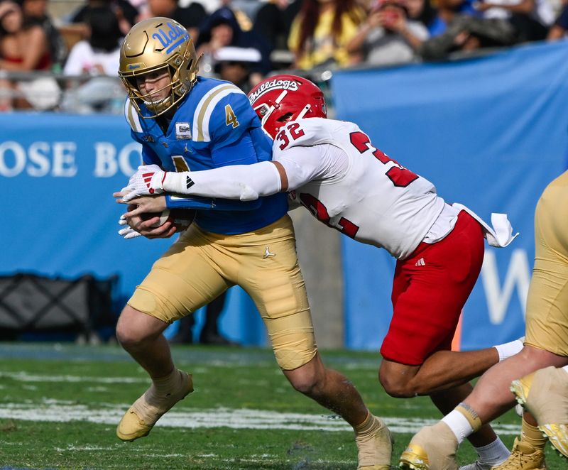 Nov 30, 2024; Pasadena, California, USA; Fresno State Bulldogs defensive back Dean Clark (32) sacks UCLA Bruins quarterback Ethan Garbers (4) during the second quarter at Rose Bowl. Mandatory Credit: Robert Hanashiro-Imagn Images