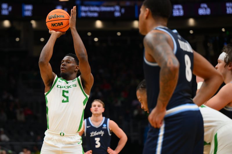 Mar 21, 2025; Seattle, WA, USA; Oregon Ducks guard TJ Bamba (5) shoots a free throw against the Liberty Flames during the second half in the first round of the NCAA Tournament at Climate Pledge Arena. Mandatory Credit: Steven Bisig-Imagn Images
