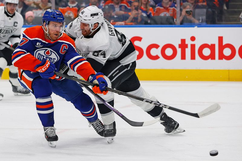 May 1, 2025; Edmonton, Alberta, CAN; Los Angeles Kings defensemen Vladislav Gavrikov (84) tries to knock the puck away from Edmonton Oilers forward Connor McDavid (97) during the first period in game six of the first round of the 2025 Stanley Cup Playoffs at Rogers Place.