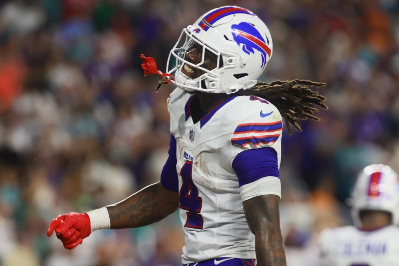 Sep 12, 2024; Miami Gardens, Florida, USA; Buffalo Bills running back James Cook (4) celebrates after scoring a touchdown against the Miami Dolphins during the second quarter at Hard Rock Stadium. Mandatory Credit: Sam Navarro-Imagn Images