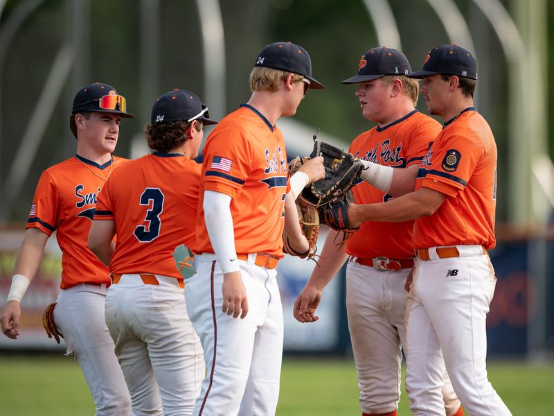 Smith Post 24 players meet up before an inning July 8 at Utica University. The team enters postseason play as the No. 1 seed.