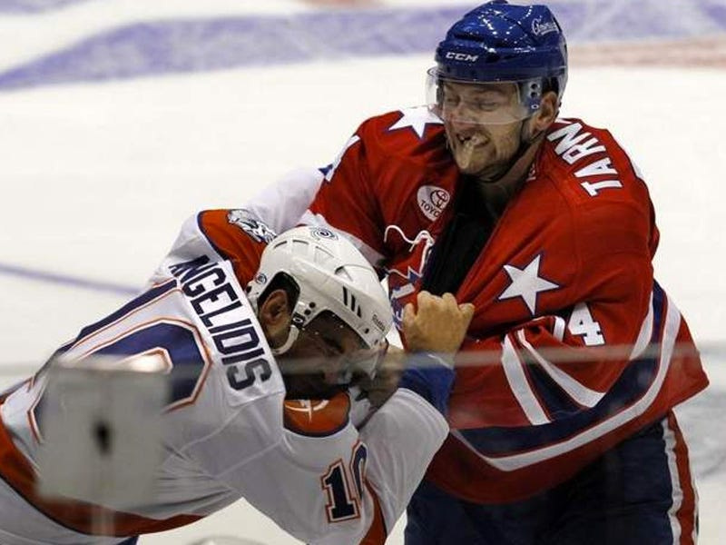 Rochester Americans forward Nick Tarnasky, right, fights Syracuse Crunch forward Mike Angelidis during the 2012-13 season.