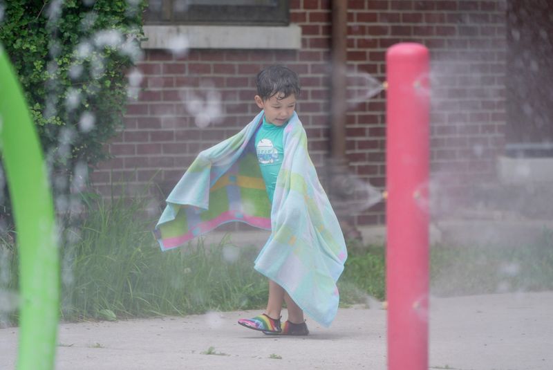 Reilly McCullough, 5, looks at the water as he heads home from playing at the spray park at Humboldt R-Center in Rochester on July 15, 2025. He was at the park with his brother and grandmother.