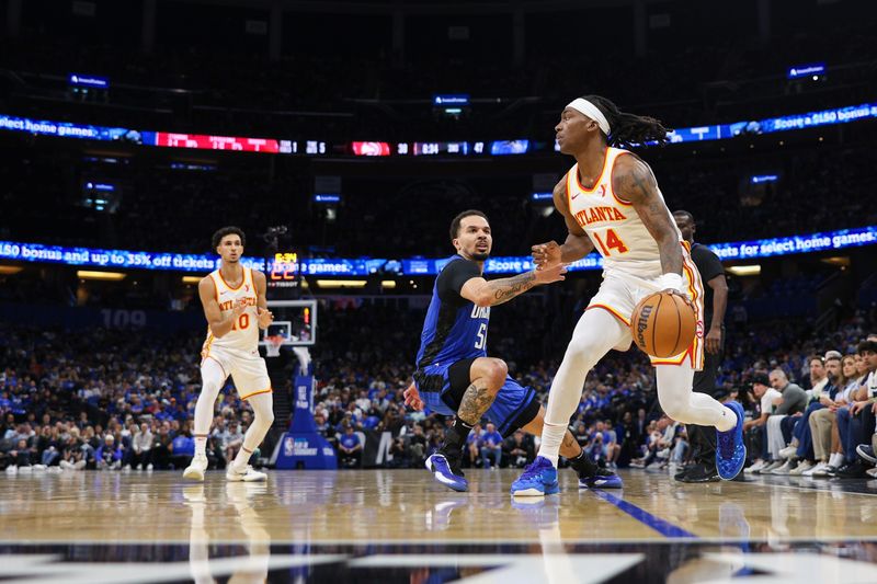 Apr 15, 2025; Orlando, Florida, USA; Atlanta Hawks guard Terance Mann (14) controls the ball against the Orlando Magic in the second quarter at Kia Center. Mandatory Credit: Nathan Ray Seebeck-Imagn Images