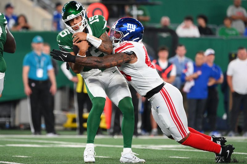 Aug 24, 2024; East Rutherford, New Jersey, USA; New York Giants linebacker Tomon Fox (45) sacks New York Jets quarterback Adrain Martinez (15) during the first half at MetLife Stadium. Mandatory Credit: Rich Barnes-USA TODAY Sports