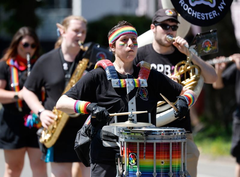 A member of the Flower City Pride Band plays with the group during the Pride Parade.