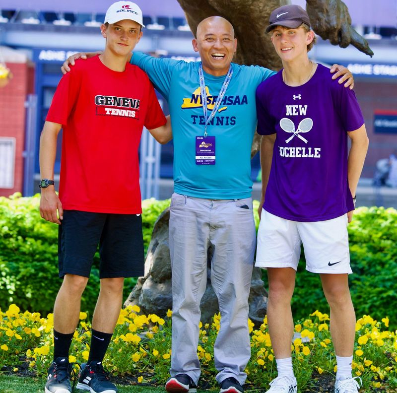 Former NYSPHSAA tennis coordinator Quan Huynh poses for a photo while flanked by Geneva High School star Drew Fishback, left, and New Rochelle's Alex Suhanitski, right, during the 2025 boys tennis state tournament.
