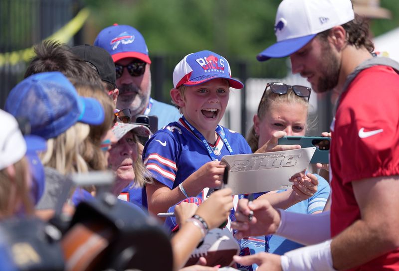 A young boy gets excited as Buffalo Bills quarterback Josh Allen works his way closer to him at the Buffalo Bills training camp at St. John Fisher University in Pittsford on July 24, 2025.