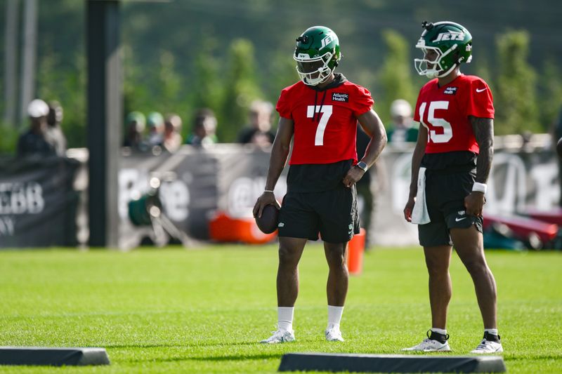 Jul 25, 2025; Florham Park, NJ, USA; New York Jets quarterbacks Justin Fields (7) and Adrian Martinez (15) look on during a drill at training camp at Atlantic Health Jets Training Center. Mandatory Credit: John Jones-Imagn Images