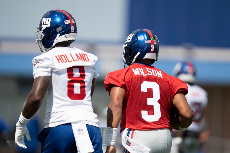 New York Giants quarterback Russell Wilson (3) and New York Giants safety Jevon Holland (8) walk next to each other during day one of the New York Giants training camp at Quest Diagnostics Giants Training Center in East Rutherford on Wednesday, July 23, 2025.