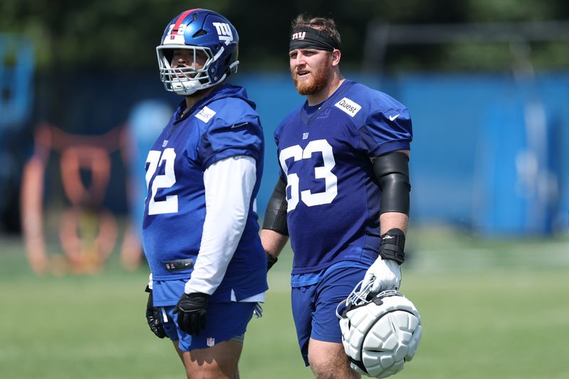 Jul 24, 2025; East Rutherford, NJ, USA; New York Giants guard Jermaine Eluemunor (72) and guard Jake Kubas (63) looks on during training camp at Quest Diagnostics Training Center. Mandatory Credit: Vincent Carchietta-Imagn Images