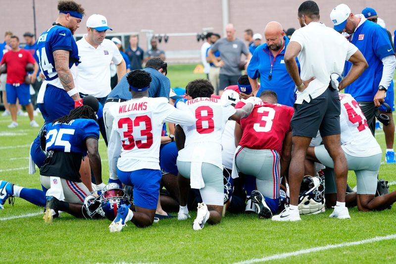 Giants players surround New York Giants wide receiver Bryce Ford-Wheaton (88), as he lays on the ground, injured, Sunday, July 27, 2025.