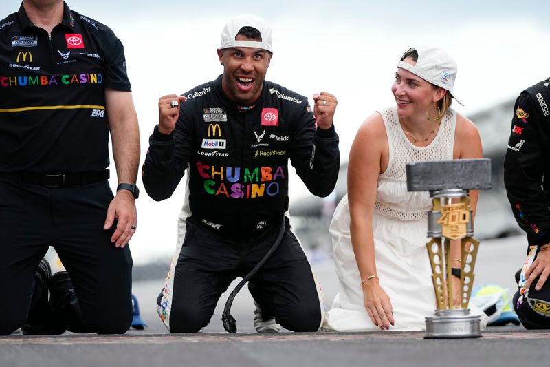 NASCAR Cup Series driver Bubba Wallace (23) celebrates on the yard of bricks Sunday, July 27, 2025, during the Brickyard 400 at Indianapolis Motor Speedway.