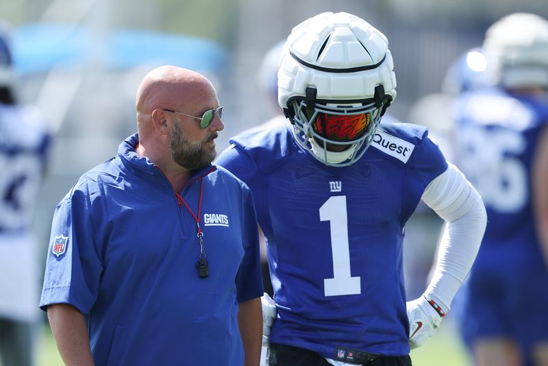 Jul 24, 2025; East Rutherford, NJ, USA; New York Giants head coach Brian Daboll talks with wide receiver Malik Nabers (1) during training camp at Quest Diagnostics Training Center. Mandatory Credit: Vincent Carchietta-Imagn Images