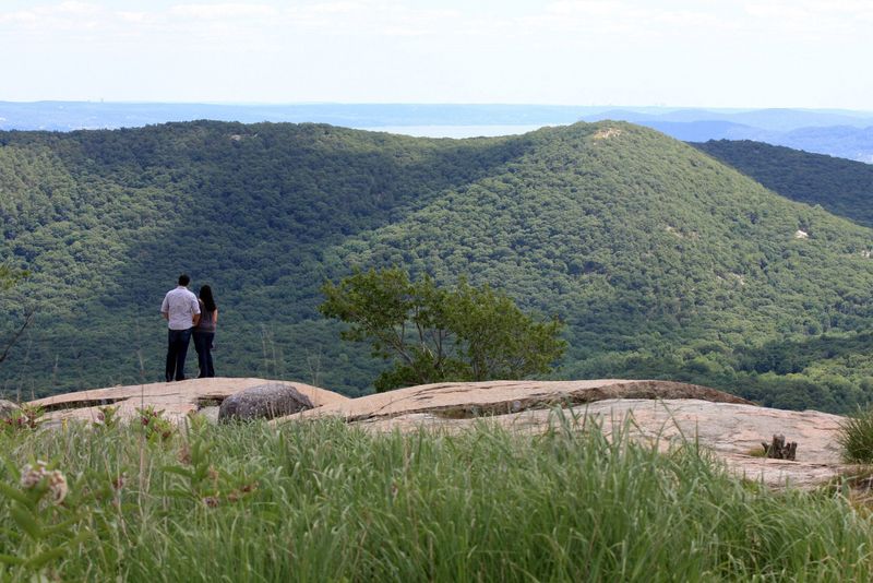 A couple take in the views from Perkins Tower at Bear Mountain State Park.