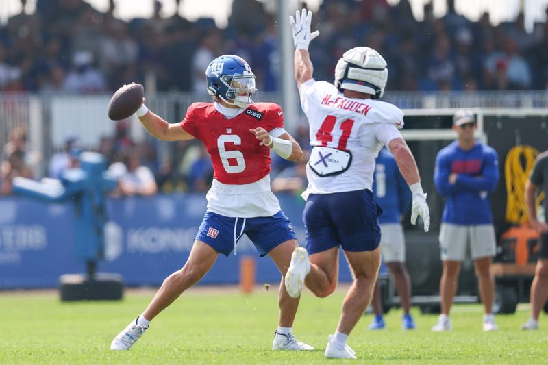 Aug 4, 2025; East Rutherford, NJ, USA; New York Giants quarterback Jaxson Dart (6) throws a pass as linebacker Micah McFadden (41) defends during training camp at Quest Diagnostics Training Center. Mandatory Credit: Vincent Carchietta-Imagn Images