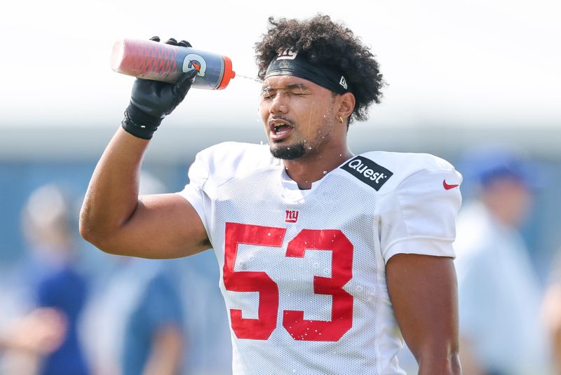Aug 4, 2025; East Rutherford, NJ, USA; New York Giants linebacker Darius Muasau (53) spays water on to his face during training camp at Quest Diagnostics Training Center. Mandatory Credit: Vincent Carchietta-Imagn Images
