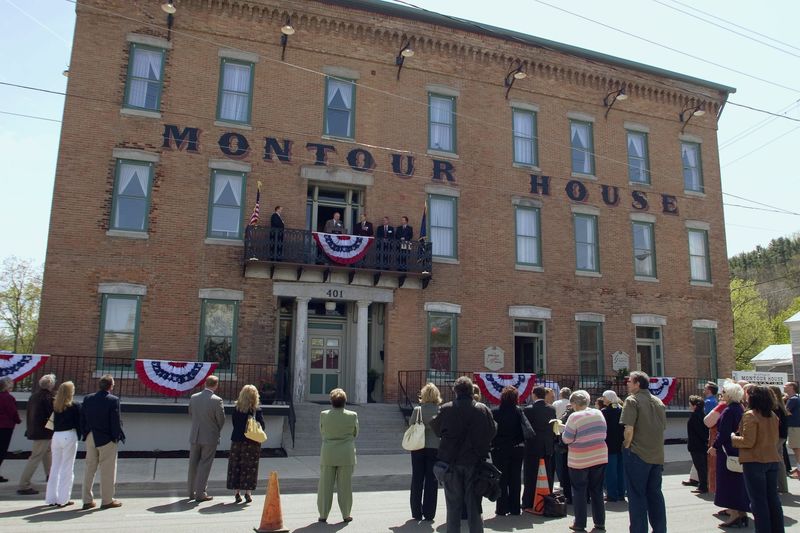 Supporters look to the second-floor balcony as the restored Montour House in the Schuyler County Village of Montour Falls is dedicated in an April 2010 ceremony.