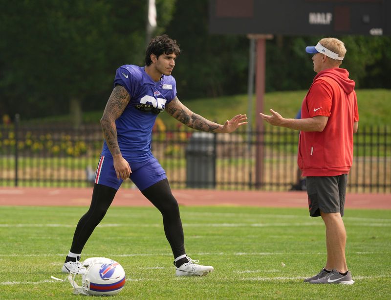 Special teams coach Chris Tabor working with linebacker Jimmy Ciarlo.