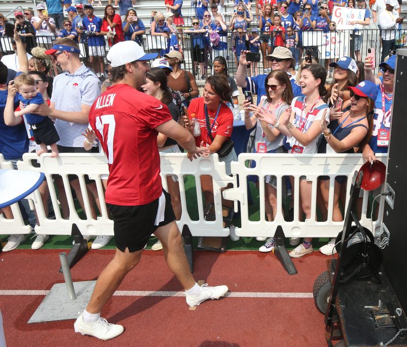 Bills quarterback Josh Allen runs the perimeter of the practice field high-fiving fans after practice during the final day of Buffalo Bills training camp at St. John Fisher University Thursday, August 7, 2025 in Pittsford, NY.