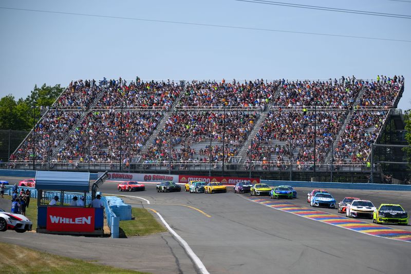 Aug 10, 2025; Watkins Glen, New York, USA; NASCAR Cup Series driver Ryan Blaney (12) leads the field out of turn one during the Go Bowling at The Glen at Watkins Glen International. Mandatory Credit: Rich Barnes-Imagn Images