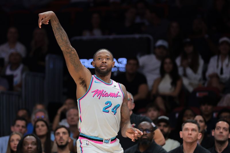Apr 7, 2025; Miami, Florida, USA; Miami Heat forward Haywood Highsmith (24) watches his shot against the Philadelphia 76ers during the second quarter at Kaseya Center. Mandatory Credit: Sam Navarro-Imagn Images
