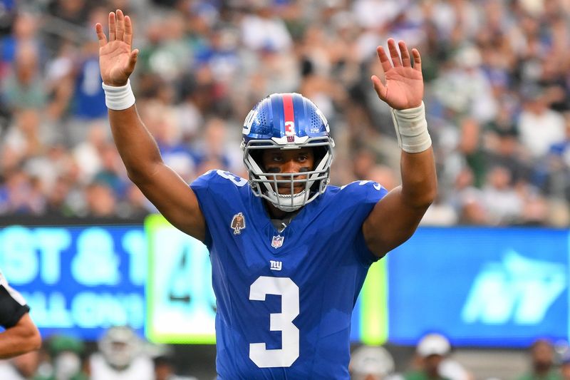 Aug 16, 2025; East Rutherford, New Jersey, USA; New York Giants quarterback Russell Wilson (3) gestures for a touchdown against the New York Jets during the first half during the first half at MetLife Stadium. Mandatory Credit: Rich Barnes-Imagn Images