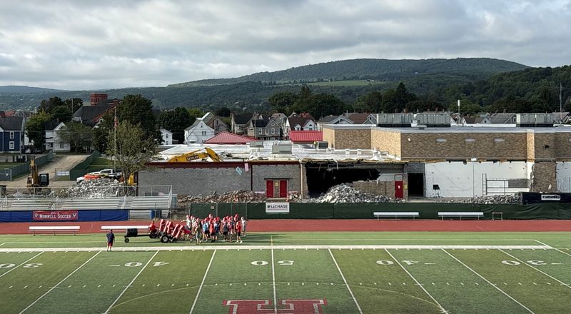 Construction crews smash a large hole in the old A gym at Hornell High School during demolition work at the site in August. The school is building a state-of-the-art competition gym, which is scheduled to open in November 2026.