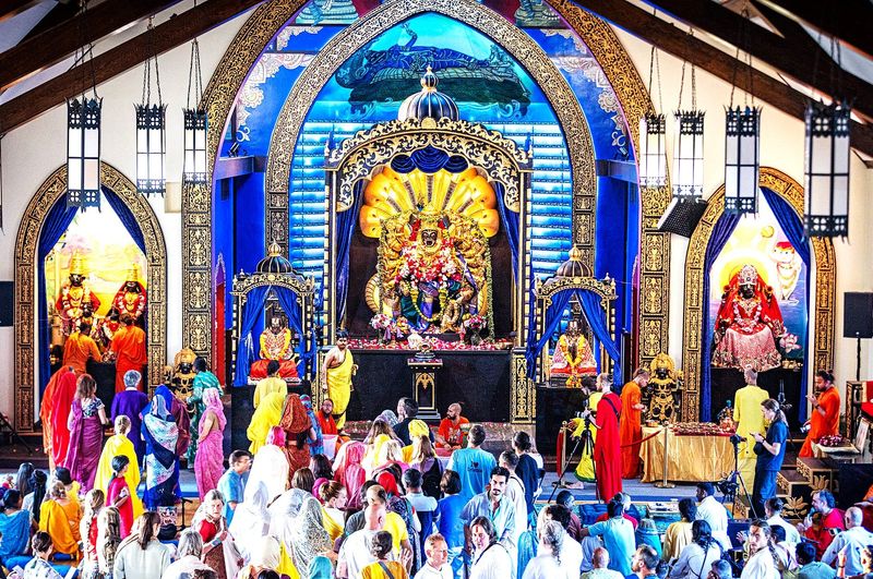 Followers of the Bhakti Marga Hindu practice take part in a celebration at Paranitya Narasimha Temple in West Elmira, the former home of Our Lady of Lourdes Catholic Church. The temple is celebrating its second anniversary in 2025.