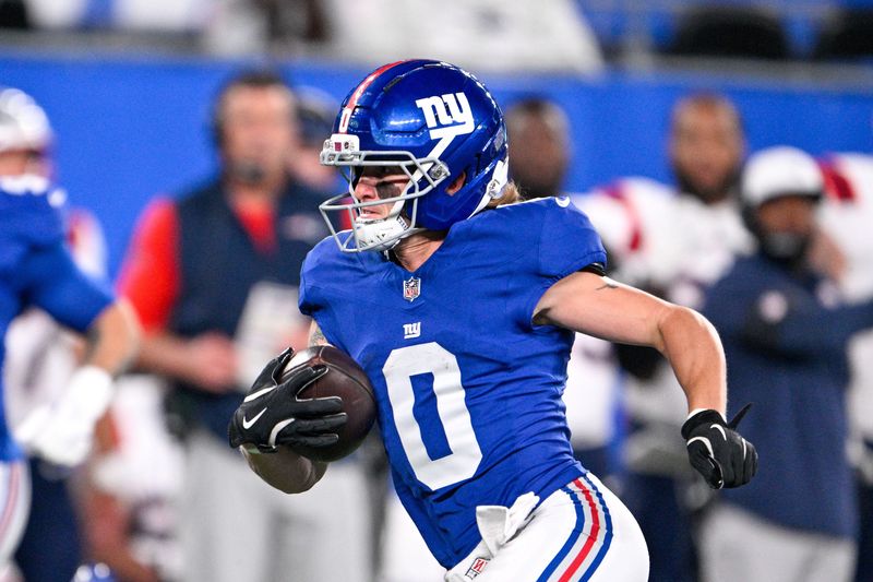 Aug 21, 2025; East Rutherford, New Jersey, USA; New York Giants wide receiver Gunner Olszewski (0) runs with the ball after a catch during the first quarter against the New England Patriots at MetLife Stadium. Mandatory Credit: Mark Smith-Imagn Images