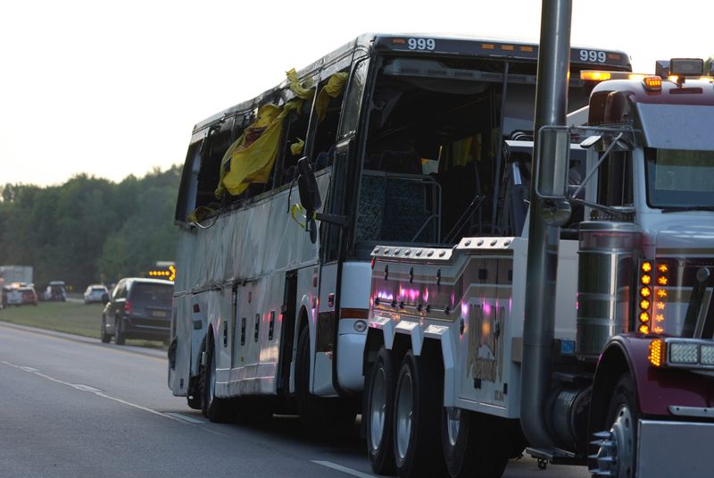 The tour bus involved in a deadly crash on the New York State Thruway near Pembroke is removed from the scene Friday evening.