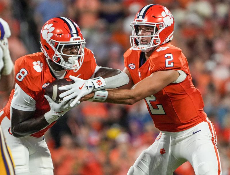 Clemson running back Adam Randall (8) takes the handoff from quarterback Cade Klubnik (2) playing LSU during the first quarter at Memorial Stadium in Clemson, S.C. Saturday, August 30, 2025.