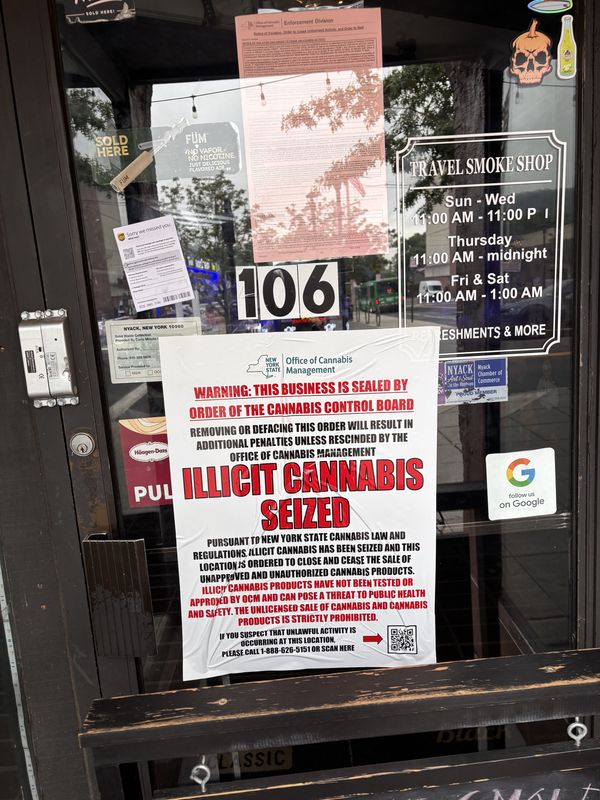 A sign posted to the front door of a smoke shop on Main Street in Nyack explains that the store was shutdown after authorities seized illicit cannabis from the property, alleging that the store was engaging in illegal sale of marijuana products.