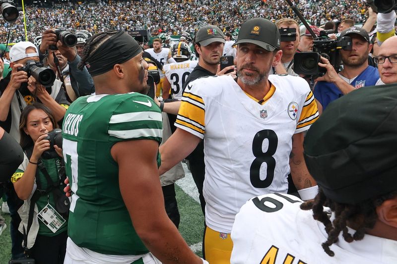 Sep 7, 2025; East Rutherford, New Jersey, USA; New York Jets quarterback Justin Fields (7) greets Pittsburgh Steelers quarterback Aaron Rodgers (8) after the game at MetLife Stadium. Mandatory Credit: Wendell Cruz-Imagn Images