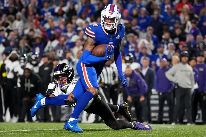 Sep 7, 2025; Orchard Park, New York, USA; Buffalo Bills wide receiver Keon Coleman (0) runs the ball against Baltimore Ravens cornerback Jaire Alexander (23) during the fourth quarter at Highmark Stadium. Mandatory Credit: Gregory Fisher-Imagn Images