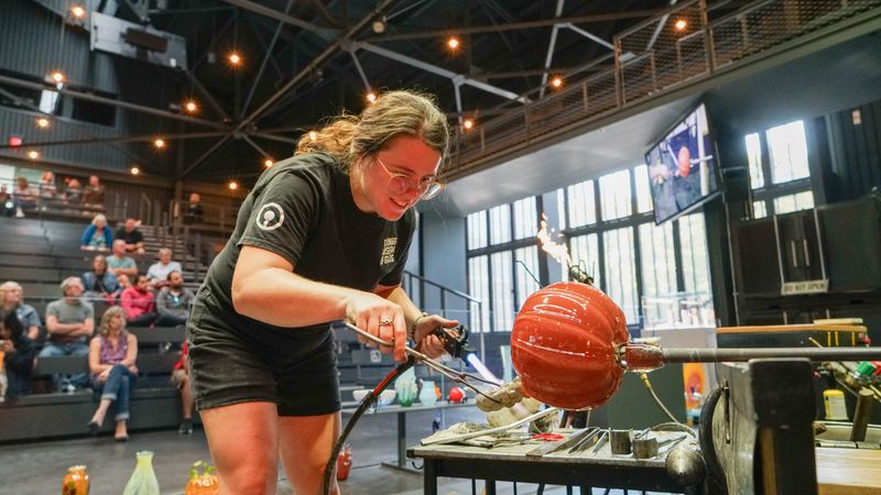 Artist and Hot Glass Team member Katie Hubbs begins her pumpkin during a Great Glass Pumpkin Experiment demonstration at the Corning Museum of Glass.