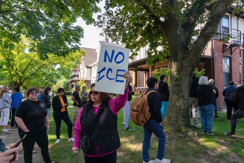 Around 200 community members gathered in Rochester Sept. 9 to block federal immigration officers from arresting roofers working on a Westminster Road home. The federal officers left after about two hours at the scene.