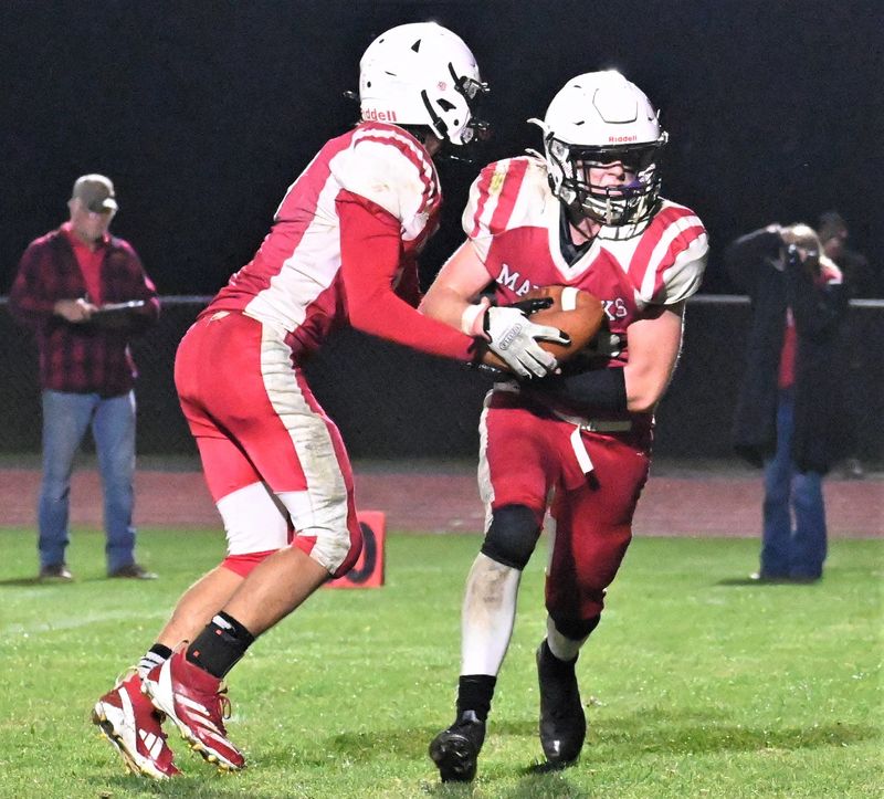 Morrisville-Eaton Maverick Mason Marland takes a handoff from quarterback Noah Mudge (left) against Frankfort-Schuyler during the fourth quarter of a Saturday, Sept. 6, 2025, game in Morrisville, New York.
